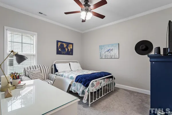 a spacious bedroom with a bed a wall painting on the wall and a large window