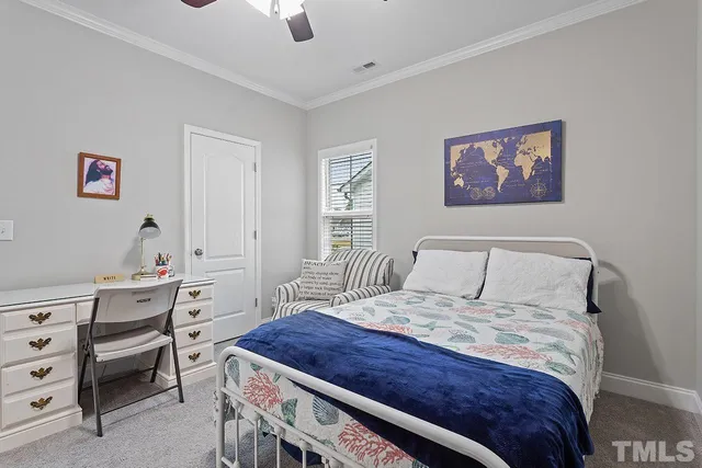 a bedroom with a bed and a desk