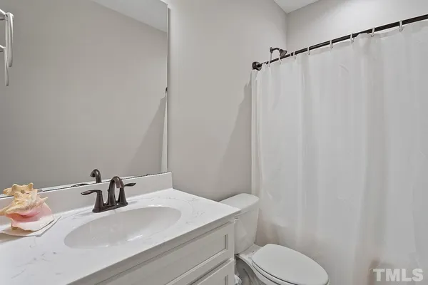 a bathroom with a sink toilet and a mirror