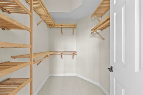 a view of walk in closet with empty racks