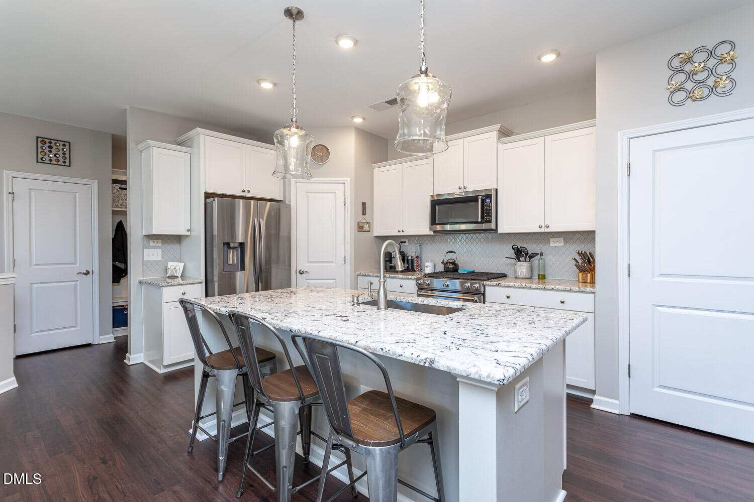 1708 Highpoint Street Wake Forest, NC 27587 - Photo 6 of 63 a kitchen with stainless steel appliances granite countertop a table chairs microwave and refrigerator