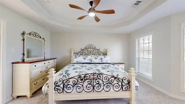 a bedroom with a bed and a dresser