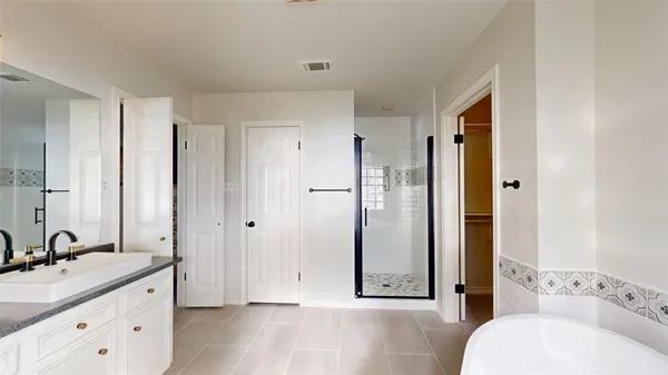 a bathroom with a granite countertop sink mirror and shower
