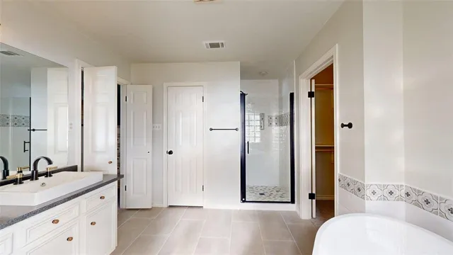 a bathroom with a granite countertop sink mirror and shower