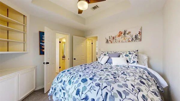 a bedroom with a large bed and a chandelier