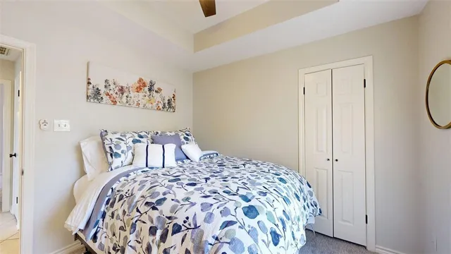 a bed sitting in a bedroom next to a bathroom