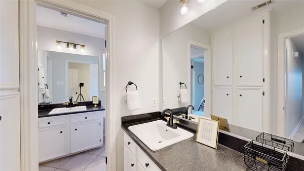 a bathroom with a double vanity sink and mirror