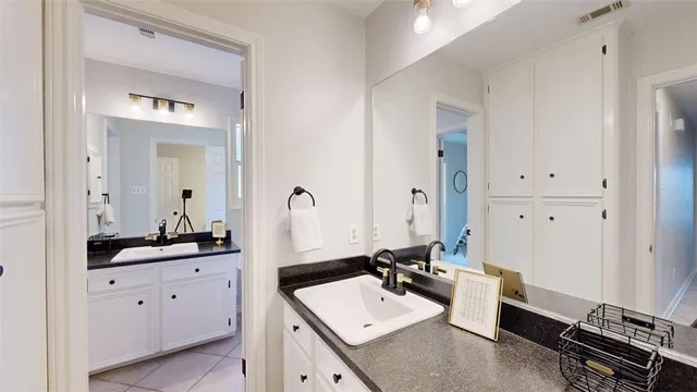 a bathroom with a double vanity sink and mirror