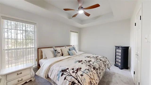 a bedroom with a large bed and a large window