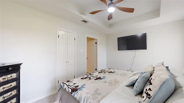 a bedroom with a bed and a flat screen tv