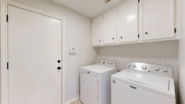 a view of storage and utility room with washer and dryer