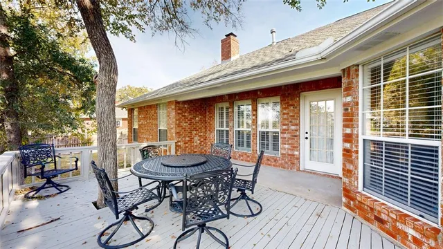 a view of a patio with table and chairs and potted plants