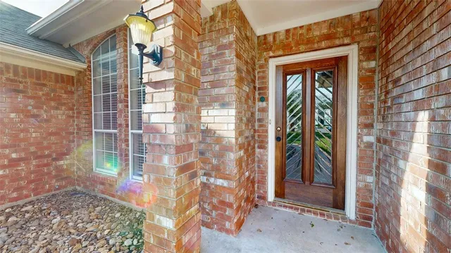 a view of a brick house with a door and balcony