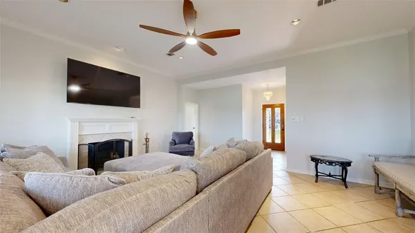 a living room with furniture a fireplace and a flat screen tv