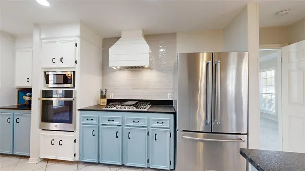 a kitchen with stainless steel appliances a refrigerator sink and cabinets