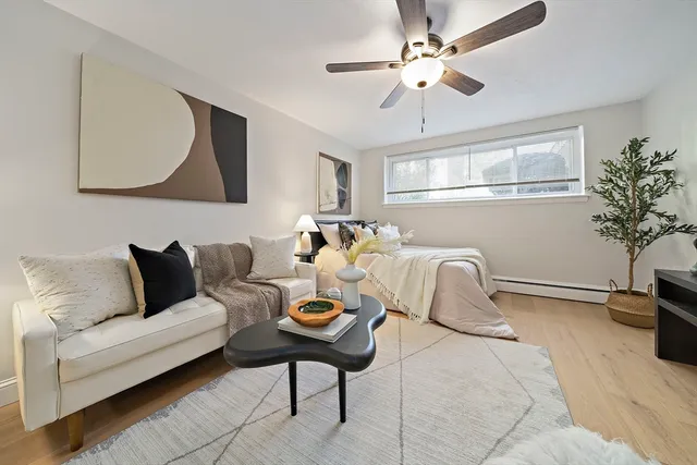 a living room with furniture a chandelier and a potted plant