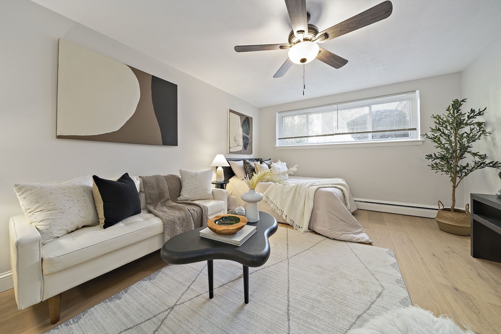 a living room with furniture a chandelier and a potted plant