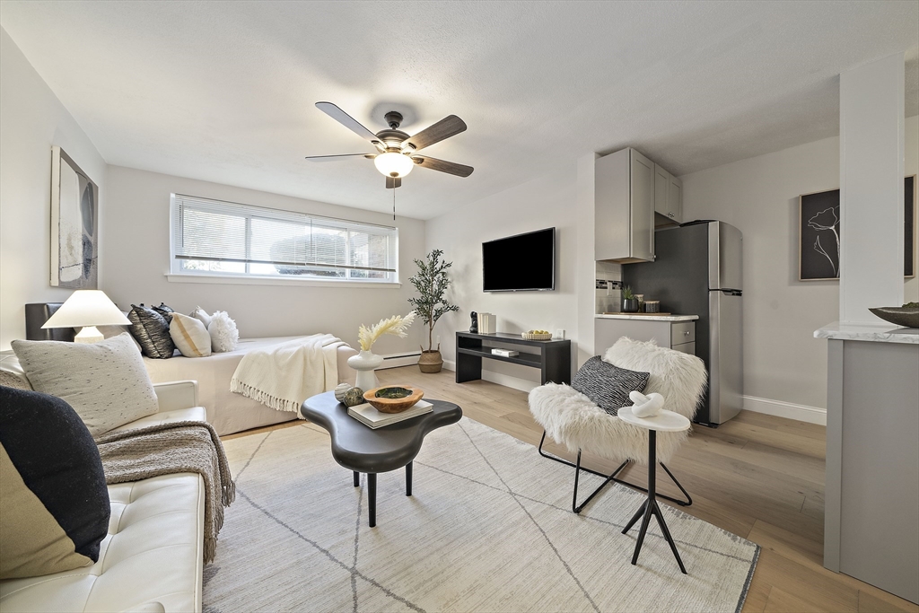 20 Radcliffe Road, Unit 112 Boston, MA 02134 - Photo 2 of 13 a living room with furniture a flat screen tv and a window