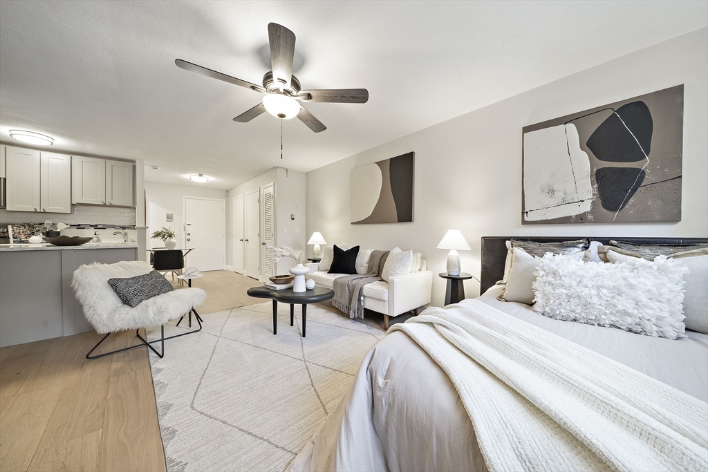 20 Radcliffe Road, Unit 112 Boston, MA 02134 - Photo 3 of 13 a bedroom with a large bed and a couch