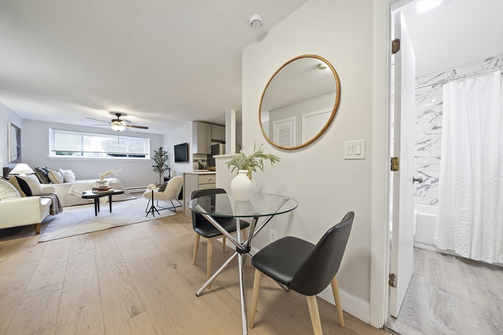20 Radcliffe Road, Unit 112 Boston, MA 02134 - Photo 9 of 13 a living room with furniture a mirror and a mirror