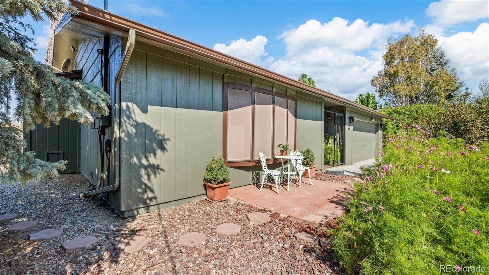 1473 17 Road Fruita, CO 81521 - Photo 16 of 35 a backyard of a house with table and chairs with potted plants