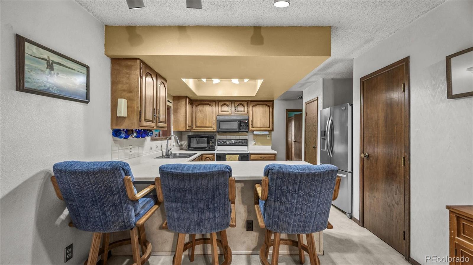 1473 17 Road Fruita, CO 81521 - Photo 25 of 35 a view of a dining room with furniture a kitchen and chandelier