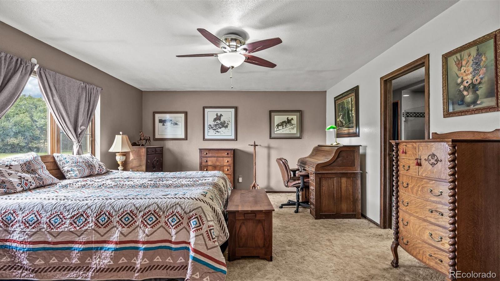 1473 17 Road Fruita, CO 81521 - Photo 28 of 35 a bedroom with a bed and wooden floor