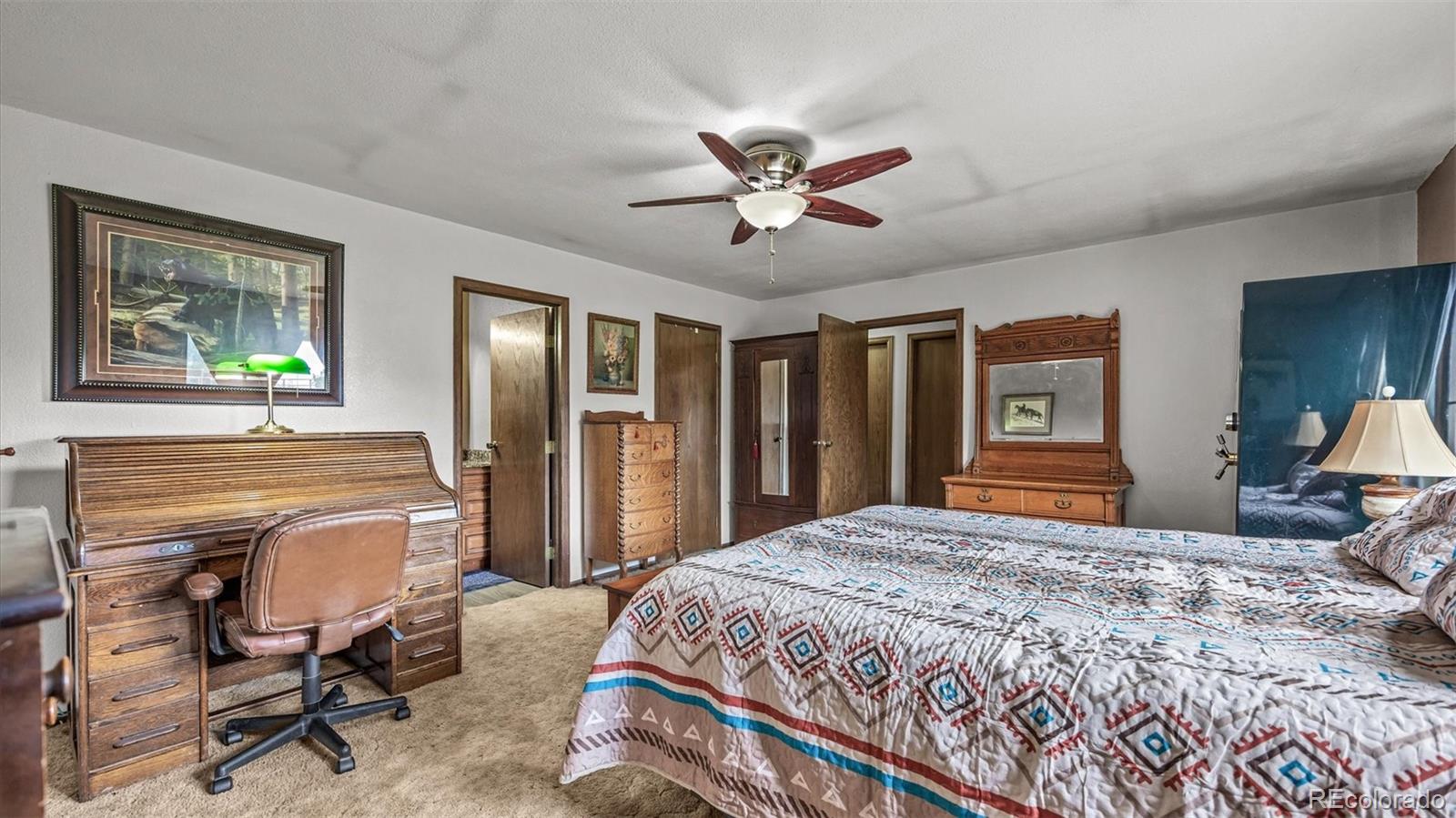 1473 17 Road Fruita, CO 81521 - Photo 29 of 35 a bedroom with a bed a desk and chair