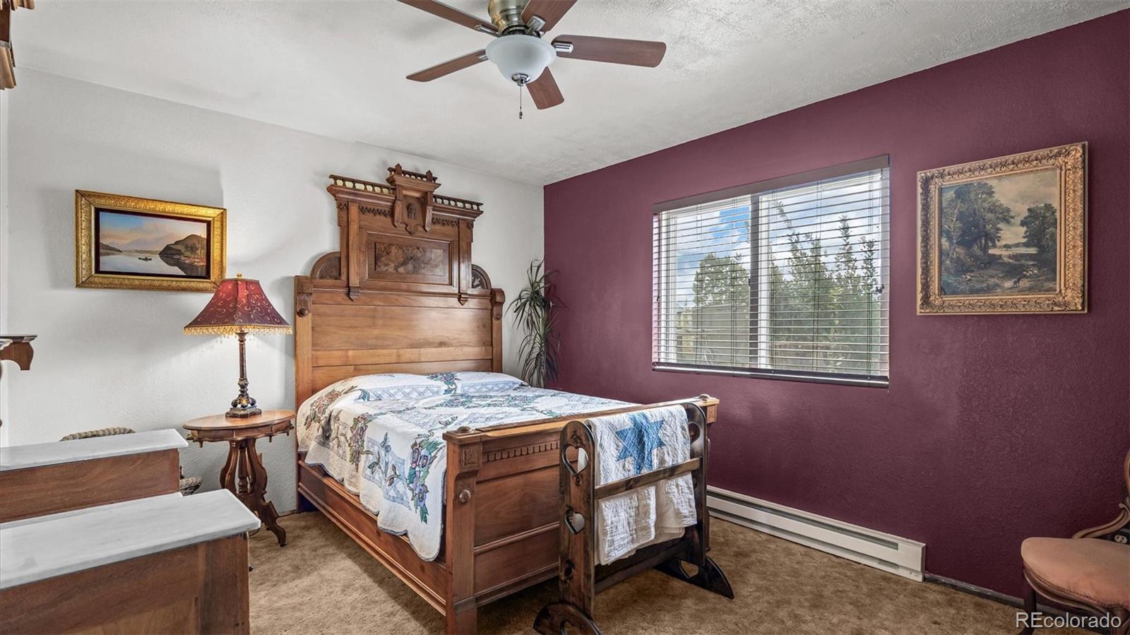 1473 17 Road Fruita, CO 81521 - Photo 30 of 35 a bedroom with a bed wooden floor and window