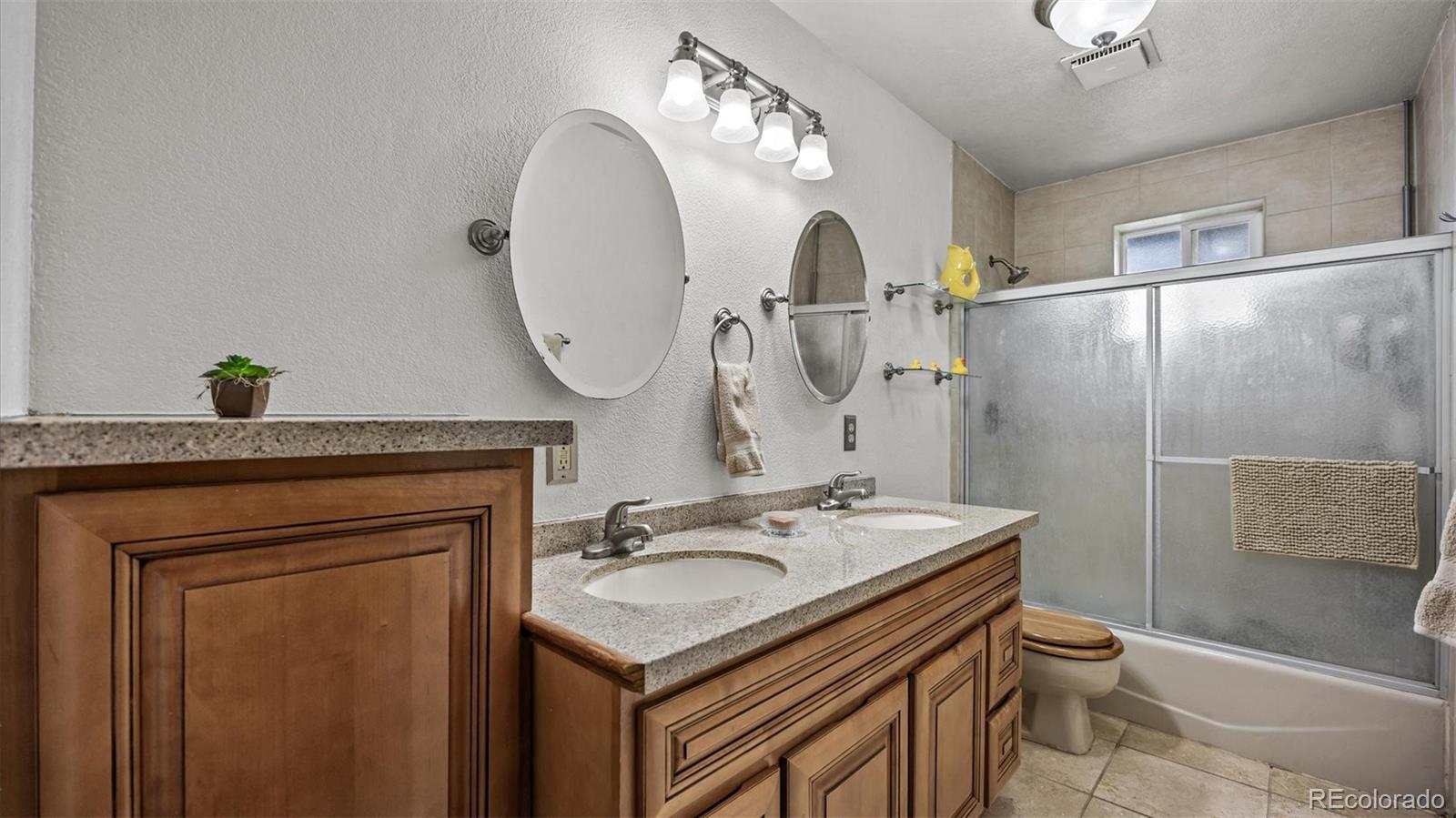 1473 17 Road Fruita, CO 81521 - Photo 31 of 35 a bathroom with a sink a toilet and a mirror