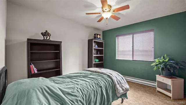 a bedroom with a bed and a potted plant