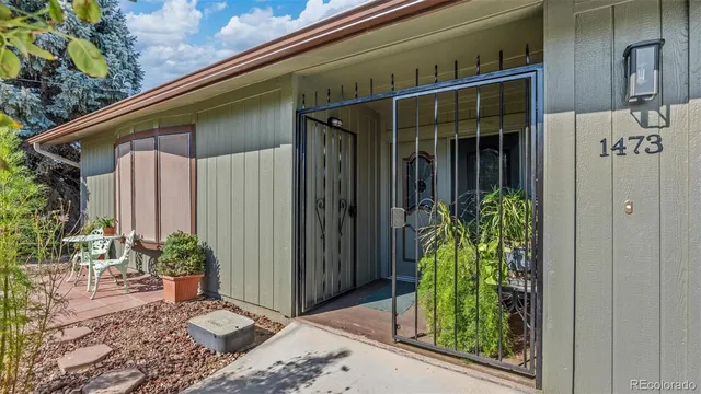 a view of a house with a big yard and large trees