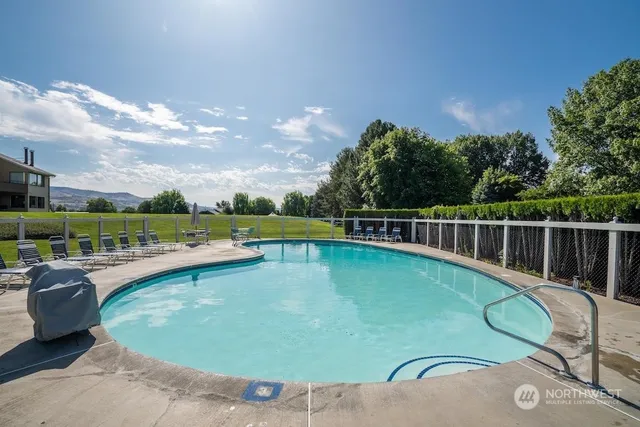 a view of a swimming pool with a lounge chair