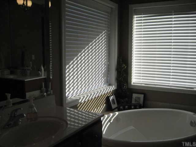665 Cole Road Clayton, NC 27520 - Photo 9 of 12 Master bath with his and hers vanities, dressing table, corner jacuzzi tub / seperate tile shower and WIC. Other