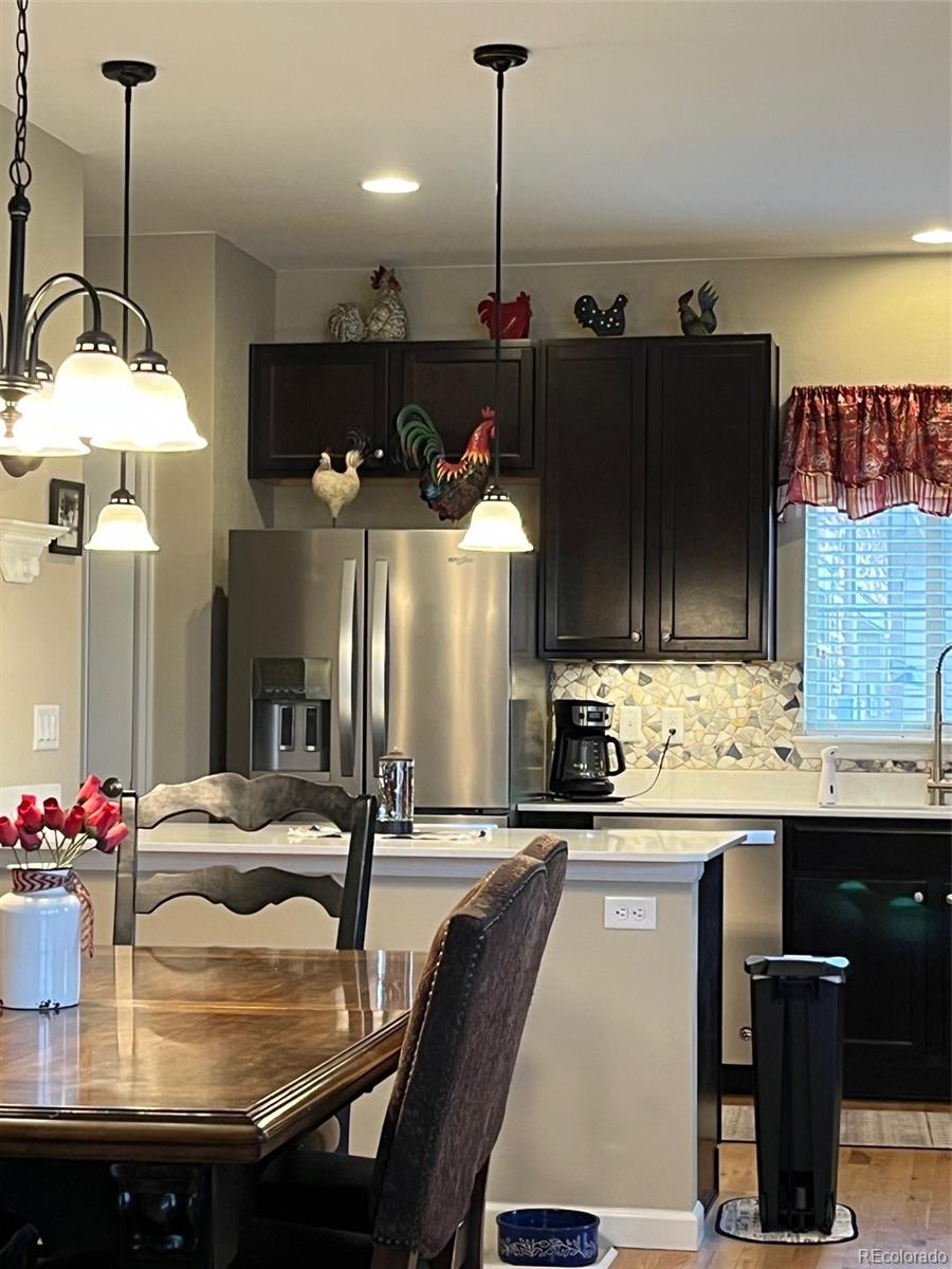 2029 South Flanders Way, Unit B Aurora, CO 80013 - Photo 13 of 42 a kitchen with a table and chairs in it