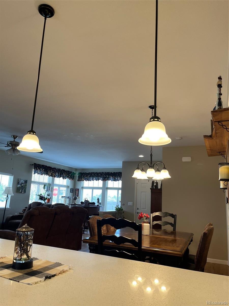 2029 South Flanders Way, Unit B Aurora, CO 80013 - Photo 15 of 42 a living room with furniture and a chandelier