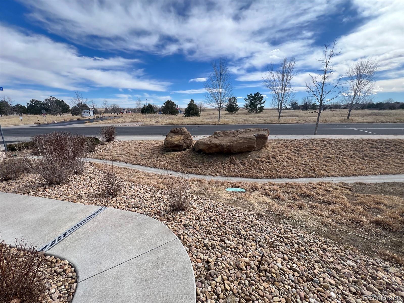 2029 South Flanders Way, Unit B Aurora, CO 80013 - Photo 2 of 42 a view of a yard with cars parked