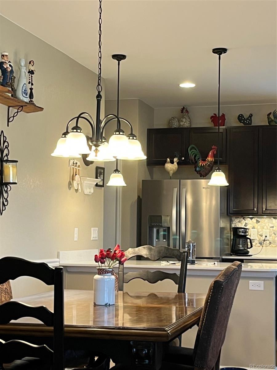 2029 South Flanders Way, Unit B Aurora, CO 80013 - Photo 21 of 42 a kitchen with a sink and chandelier