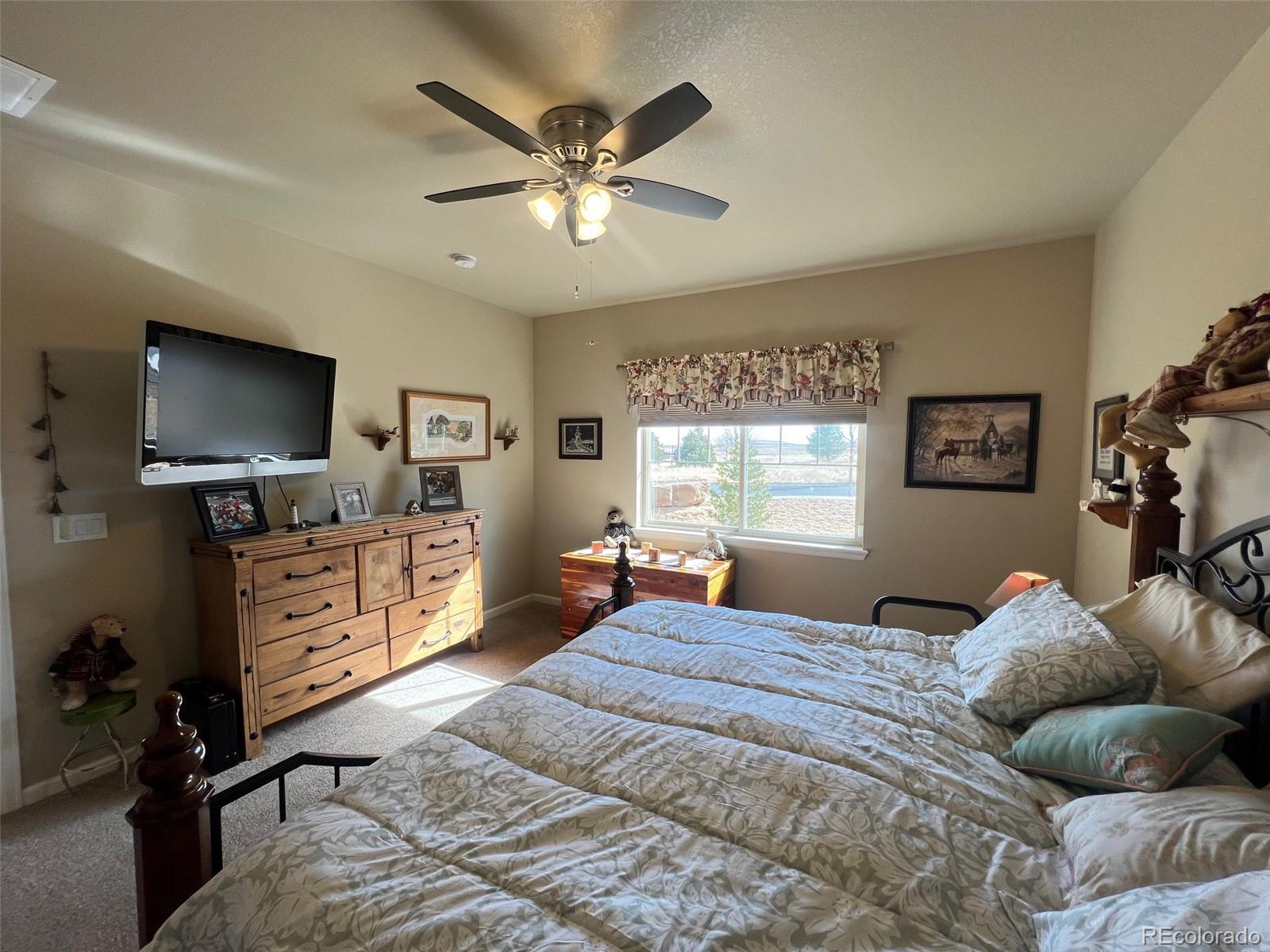 2029 South Flanders Way, Unit B Aurora, CO 80013 - Photo 23 of 42 a bedroom with furniture and a flat screen tv