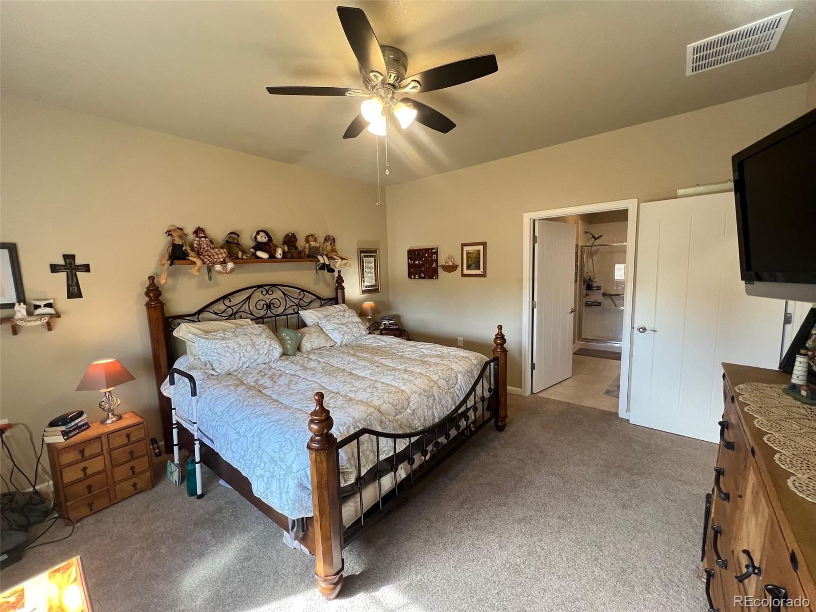 2029 South Flanders Way, Unit B Aurora, CO 80013 - Photo 24 of 42 a bedroom with a bed and a chandelier