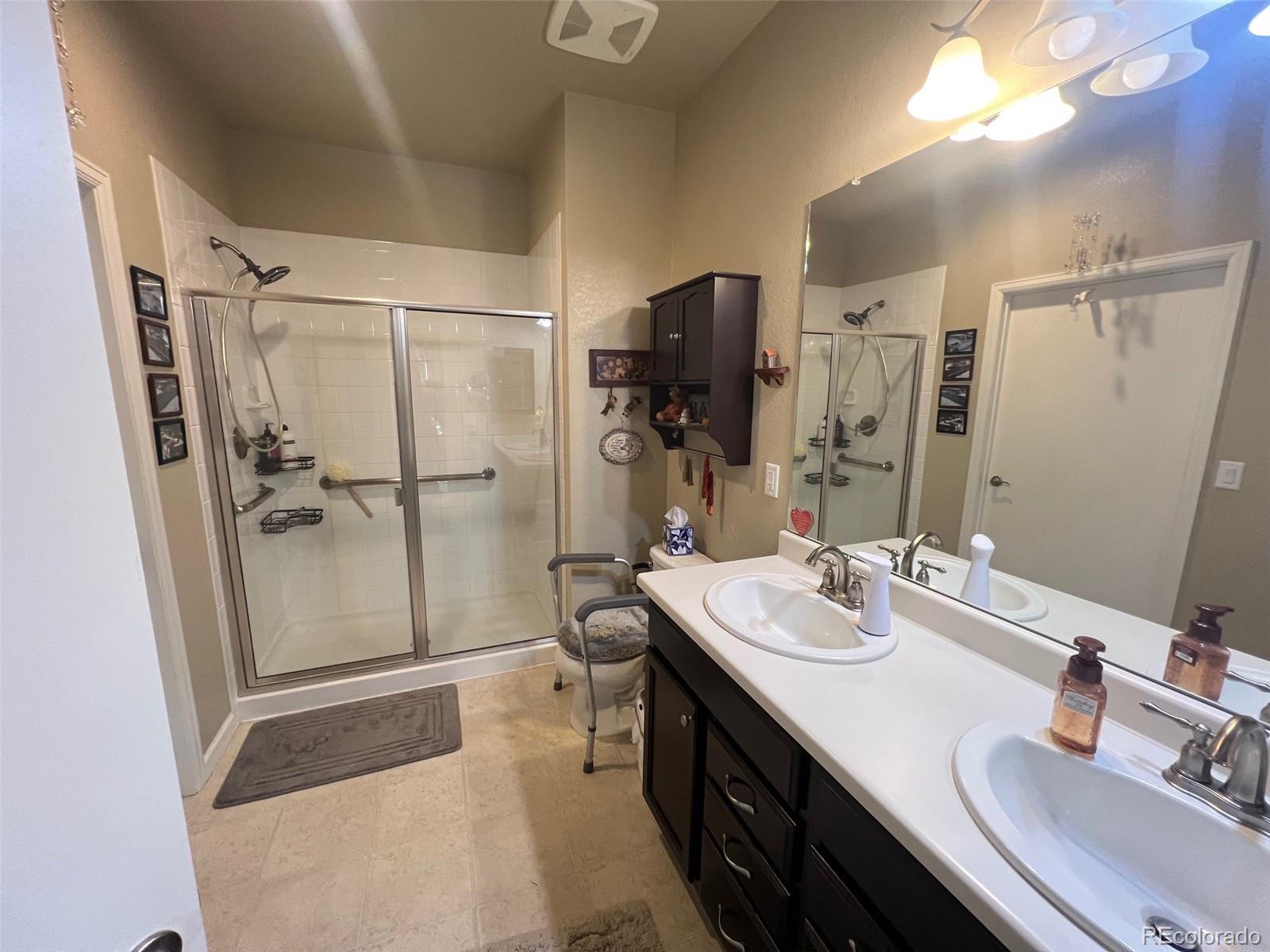 2029 South Flanders Way, Unit B Aurora, CO 80013 - Photo 25 of 42 a bathroom with double vanity sink and a mirror