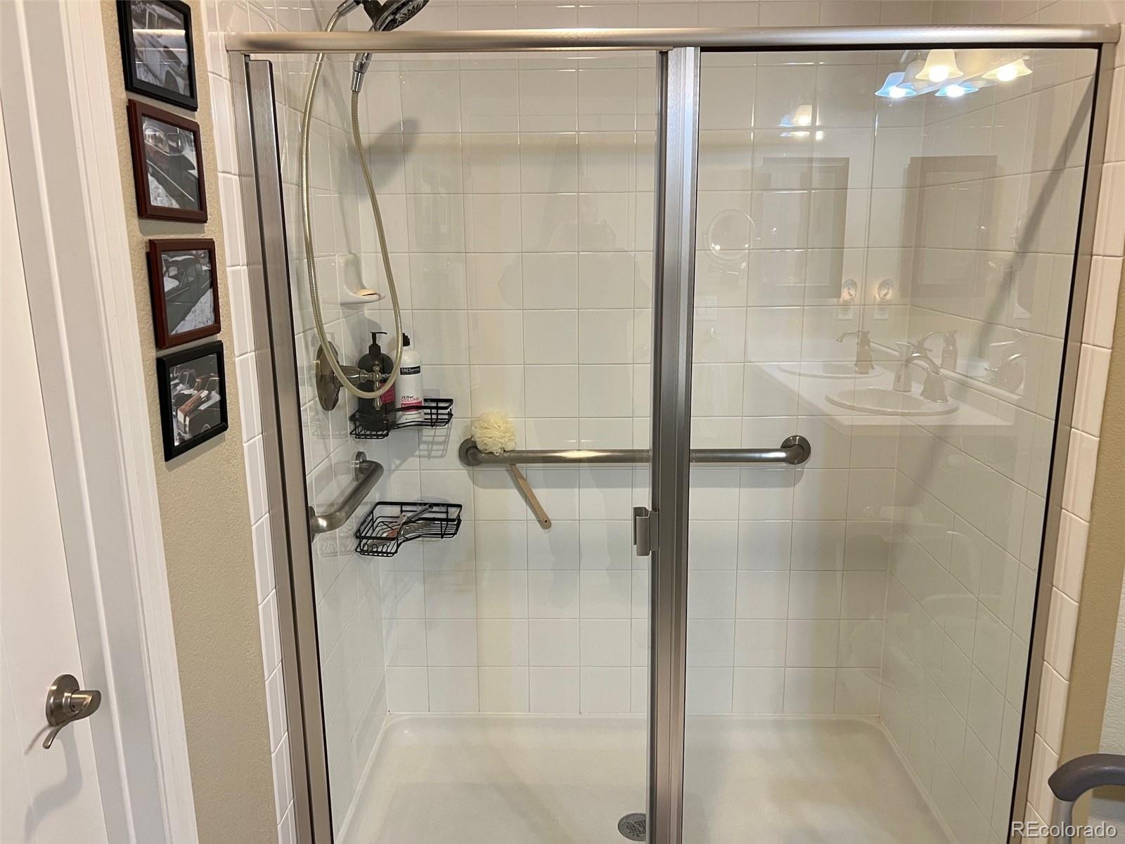 2029 South Flanders Way, Unit B Aurora, CO 80013 - Photo 26 of 42 a bathroom with a glass shower door