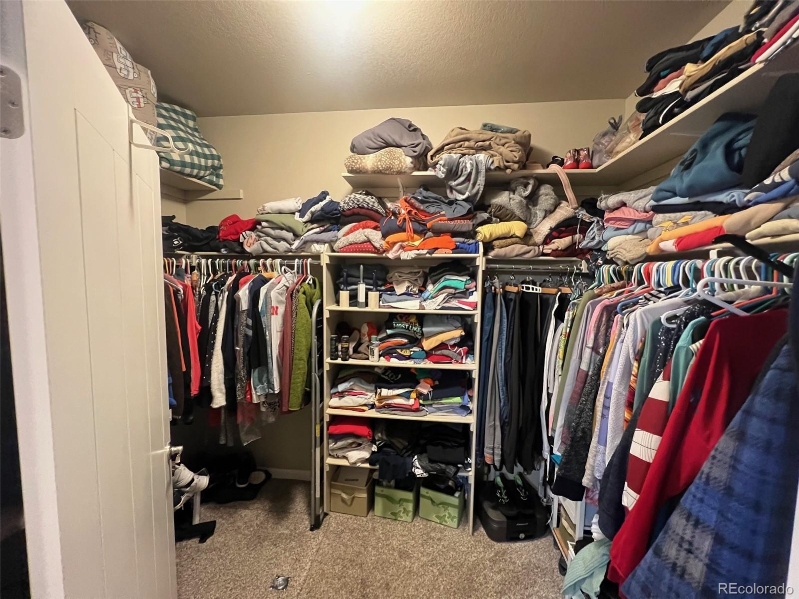 2029 South Flanders Way, Unit B Aurora, CO 80013 - Photo 27 of 42 a view of walk in closet with clothes