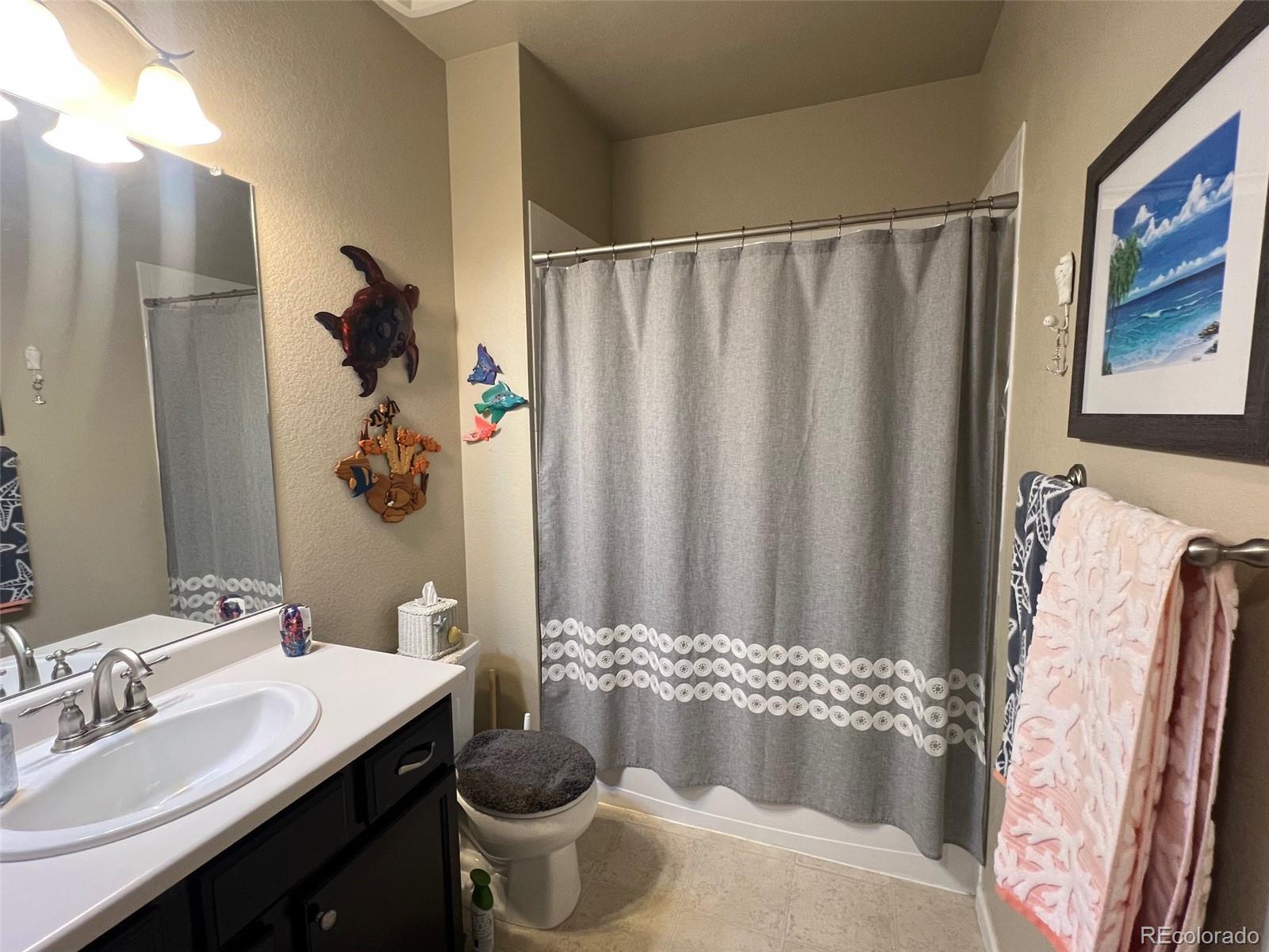 2029 South Flanders Way, Unit B Aurora, CO 80013 - Photo 29 of 42 a bathroom with a granite countertop sink and a mirror