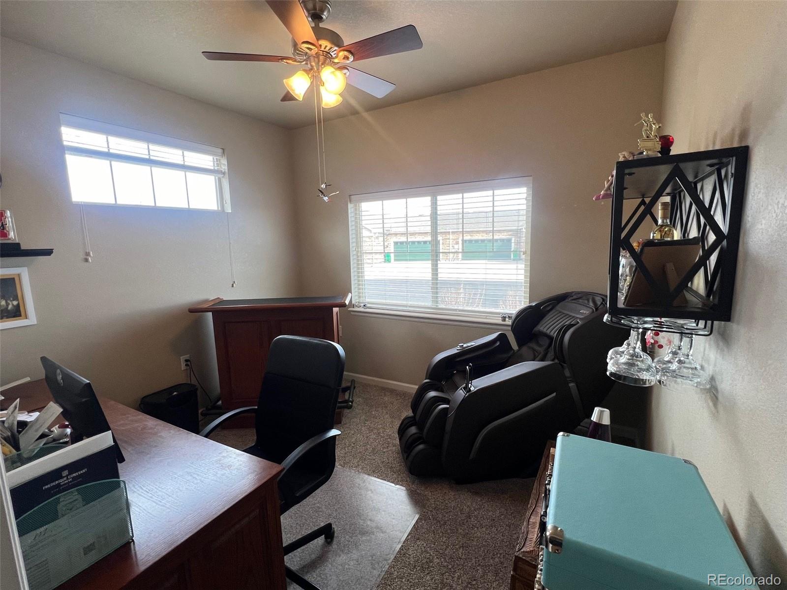2029 South Flanders Way, Unit B Aurora, CO 80013 - Photo 30 of 42 a view of workspace with wooden floor windows gym equipment and windows