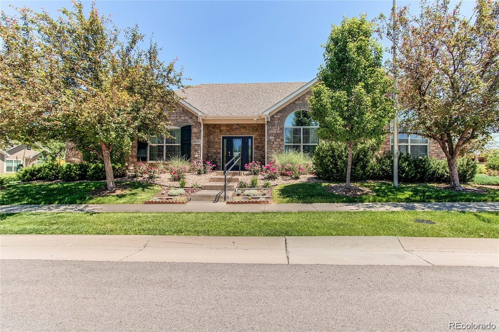 2029 South Flanders Way, Unit B Aurora, CO 80013 - Photo 38 of 42 a front view of house with a garden and trees