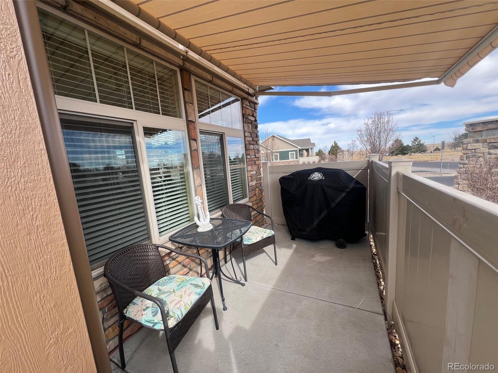 2029 South Flanders Way, Unit B Aurora, CO 80013 - Photo 8 of 42 a balcony with furniture and a potted plant