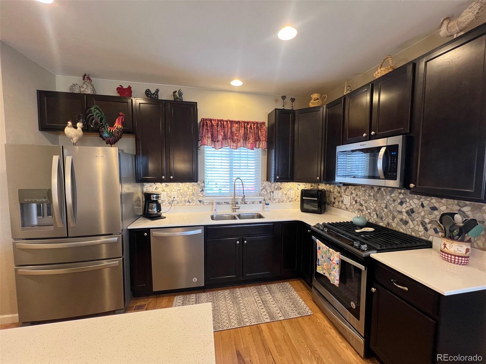 2029 South Flanders Way, Unit B Aurora, CO 80013 - Photo 10 of 42 a kitchen with stainless steel appliances granite countertop a sink stove and refrigerator