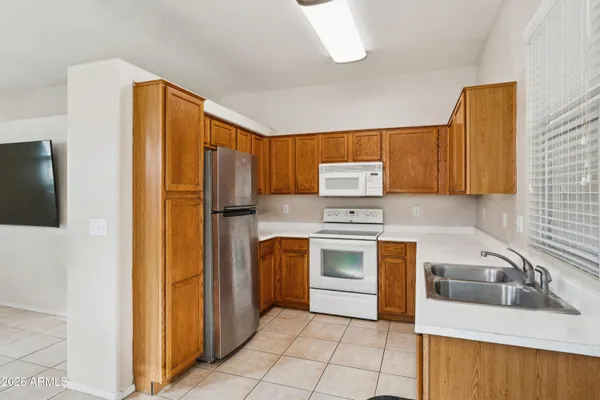 a kitchen with a refrigerator sink and stove