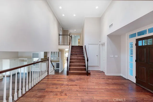 a view of entryway and hall with wooden floor